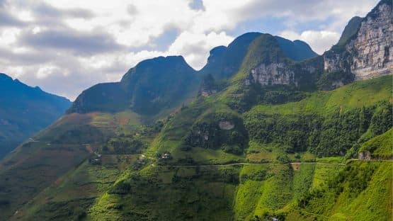 Scenic mountain valley in Ha Giang covered in mist - the perfect route for customized eco and nature tours in Northern Vietnam.